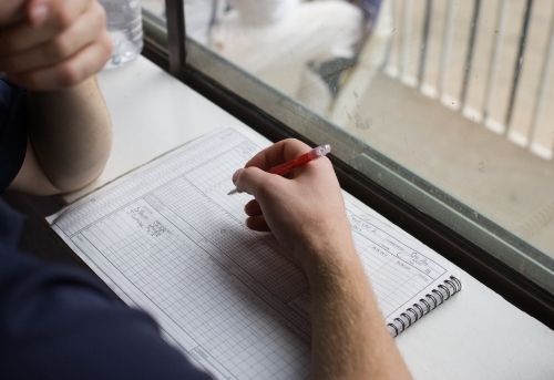Man scoring at a cricket match - Australian Stock Image