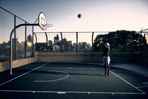Man shooting basketball - Australian Stock Image