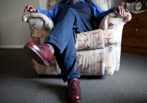 Man sitting in chair - Australian Stock Image