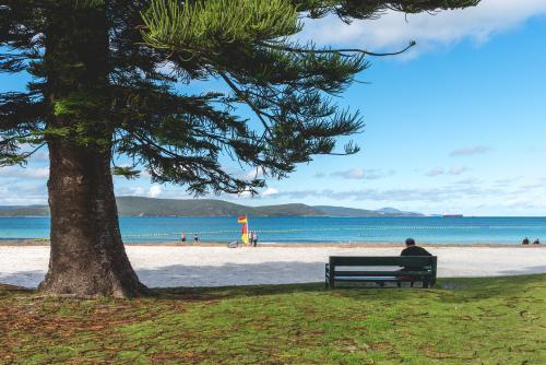 Man sitting on a bench at a typical Australian beach