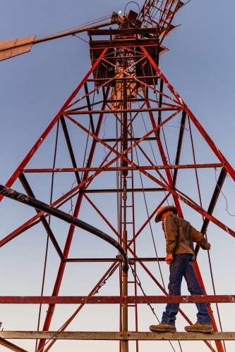 Man standing on a windmill tower - Australian Stock Image