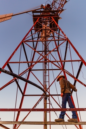 Man standing on a windmill tower