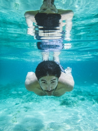 Man swimming underwater - Australian Stock Image