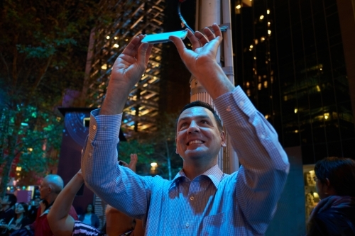 Man taking photos at night in City of Sydney - Australian Stock Image