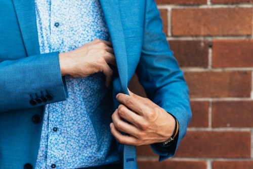 man taking something out of his suit jacket - Australian Stock Image