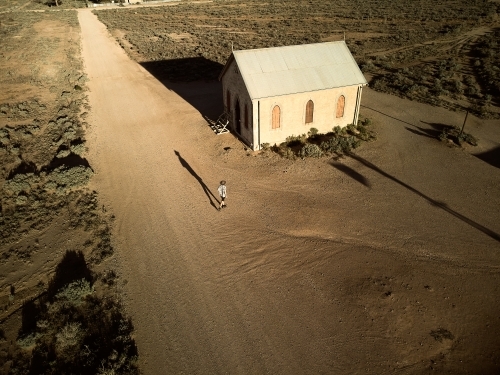 Man walking down the main street of Silverton, New South Wales - Australian Stock Image