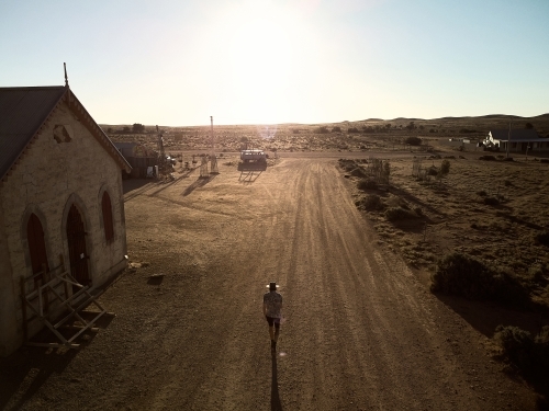 Man walking down the main street of Silverton, New South Wales - Australian Stock Image