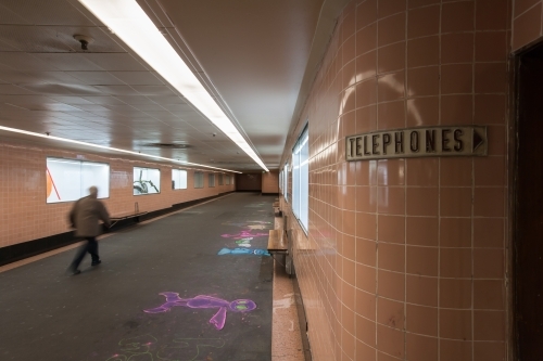 Man walking through underground train station - Australian Stock Image