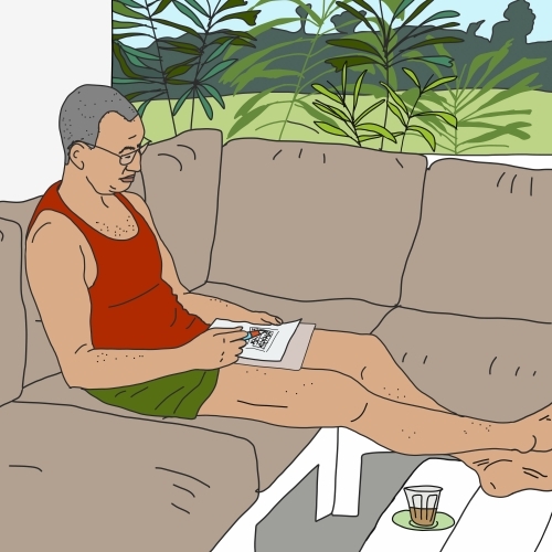 Man with bare feet sitting on balcony completing weekend puzzle