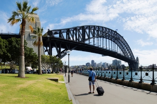 Man with luggage looking at Sydney Harbour Bridge - Australian Stock Image