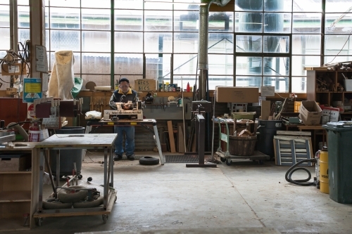 Man working on a lathe in a men's shed - Australian Stock Image