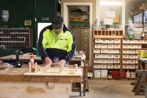 Man working on a project at a Men's shed - Australian Stock Image