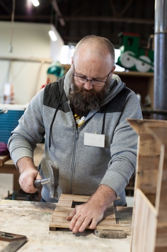 Man working on a project at a Men's shed - Australian Stock Image