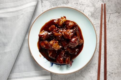 Marinated pork ribs dish on table - Australian Stock Image