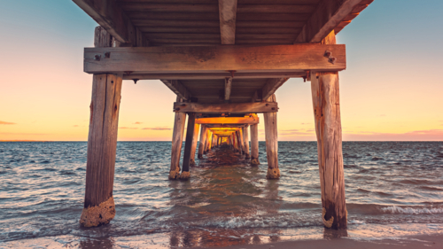 Marion Bay jetty viewed from underneath at sunset, Yorke Peninsula, South Australia - Australian Stock Image