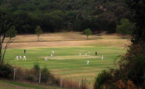 Marist Park Cricket Ground with Cricket Game in Distance - Australian Stock Image