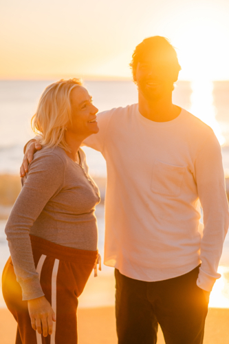 Maternity couple at Manly Beach during sunrise - Australian Stock Image