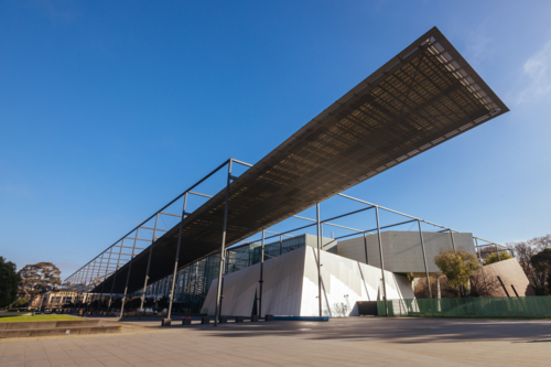 Melbourne Museum and Carlton Gardens on a clear sunny day - Australian Stock Image