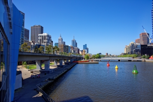 Melbourne Yarra river with oncoming train overlooking city - Australian Stock Image