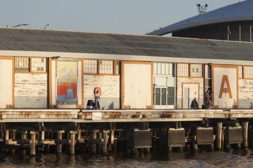 Men fishing near A Sheds at Fremantle Ports - Australian Stock Image