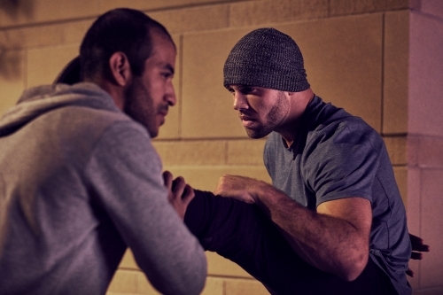 Men fitness training in urban area at night - Australian Stock Image