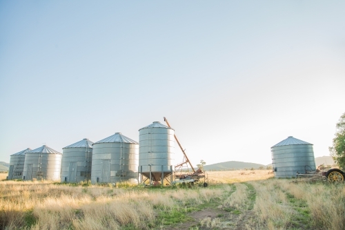 Metal grain silos on a farm in the morning