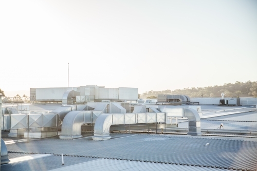 Metallic roof with vents shining in the sunlight - Australian Stock Image