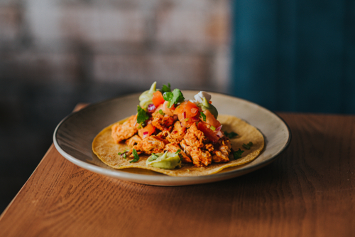 Mexican Chicken Taco Served With Fresh herbs and avocado - Australian Stock Image