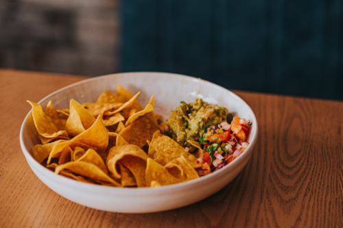 Mexican Tortilla Chips With Guacamole and Pico De Gallo Served in a Bowl - Australian Stock Image