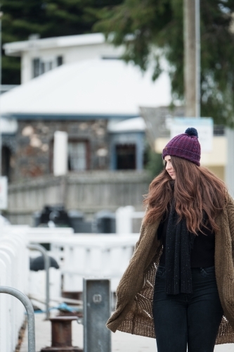 Mid twenties woman walking in winter clothes. - Australian Stock Image