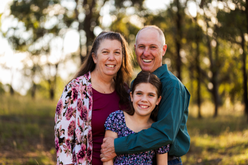 middle aged parents with tween daughter in country setting - Australian Stock Image