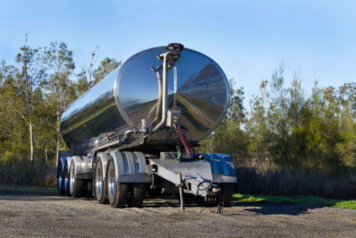 Milk tanker trailer parked up in the bush - Australian Stock Image
