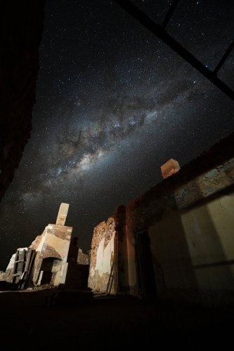 milky way over stone building - Australian Stock Image