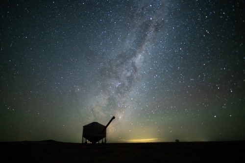 Milky Way setting behind farming containers in the Australian night sky. - Australian Stock Image