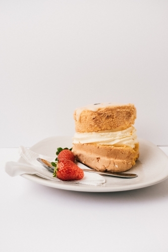 Mini passionfruit sponge cake with strawberries and cream.