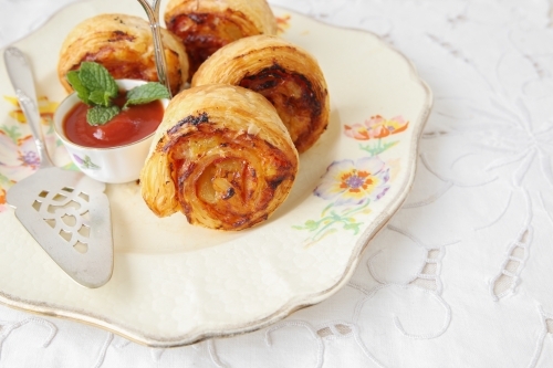 mini pizza rolls on vintage serving plate - Australian Stock Image