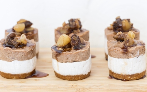 Mini raw Macadamia, choc cheesecakes served on a board - Australian Stock Image