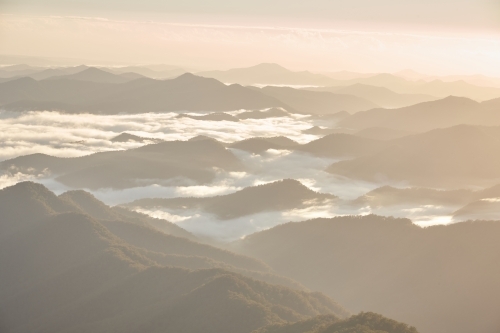 Misty mountain range during sunrise - Australian Stock Image
