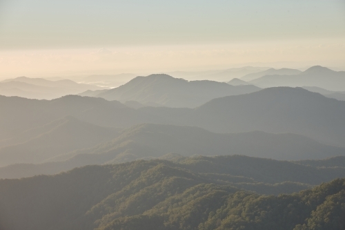 Misty mountain range during sunset - Australian Stock Image