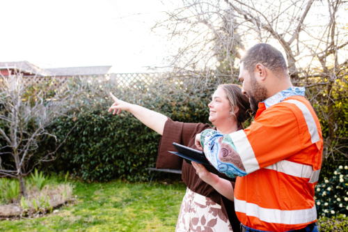 Mixed ethnicity couple planning a renovation in their backyard - Australian Stock Image