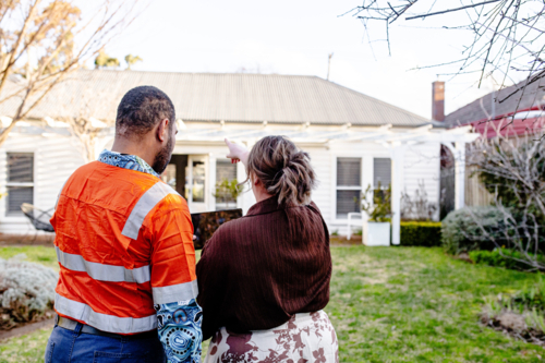 Mixed ethnicity couple planning a renovation in their backyard - Australian Stock Image