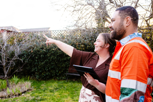 Mixed ethnicity couple planning a renovation in their backyard - Australian Stock Image