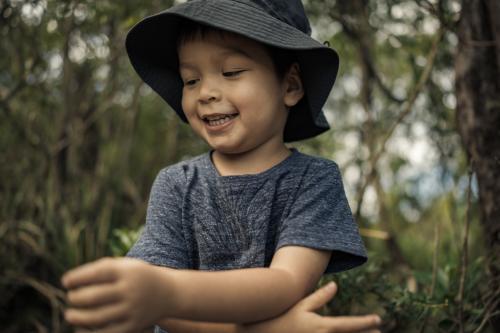 Mixed race boys bushwalking wearing hats in Barrington Tops National Park - Australian Stock Image