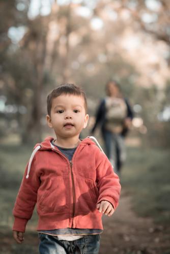 Mixed race boys walk with their Asian mother in a Sydney suburban park - Australian Stock Image