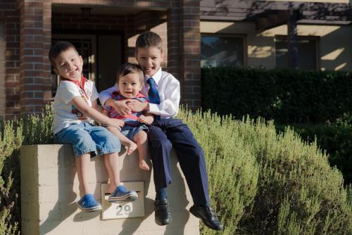 Mixed race brothers play together in the yard of their suburban Sydney home - Australian Stock Image