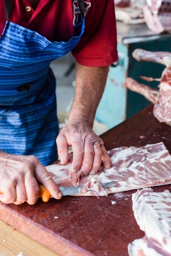mobile butcher cutting up lamb meat