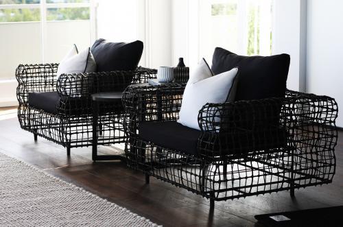 Modern lounge chairs inside a room lit with natural light - Australian Stock Image