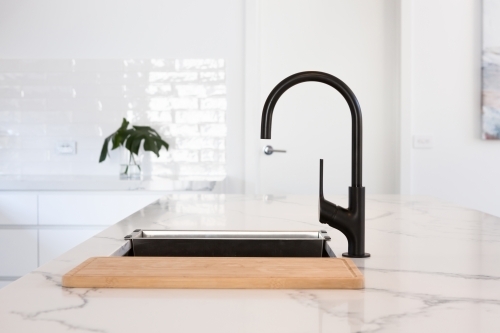 Monochrome kitchen detail of black gooseneck tap - Australian Stock Image