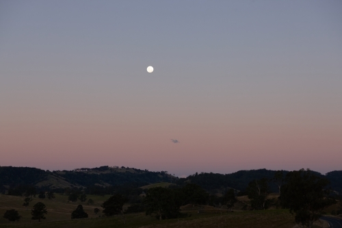 Moon rising over landscape - Australian Stock Image