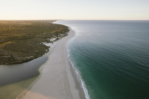 Moore River meeting the Indian Ocean at sunrise in Western Australia - Australian Stock Image